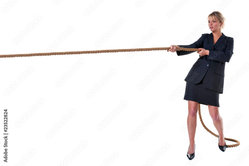 Blond businesswoman pulling on rope Blond businesswoman pulling on rope
