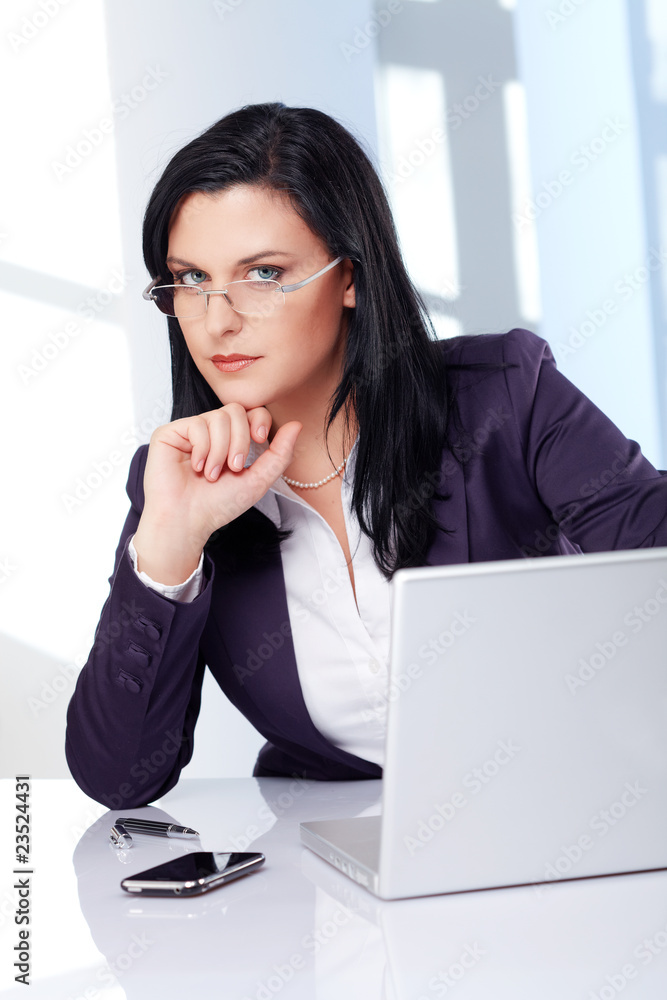 stern looking business lady in modern office stern looking business lady in modern office