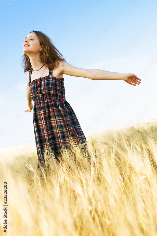 Beautfiul woman in checkered dress in a field Beautfiul woman in checkered dress in a field