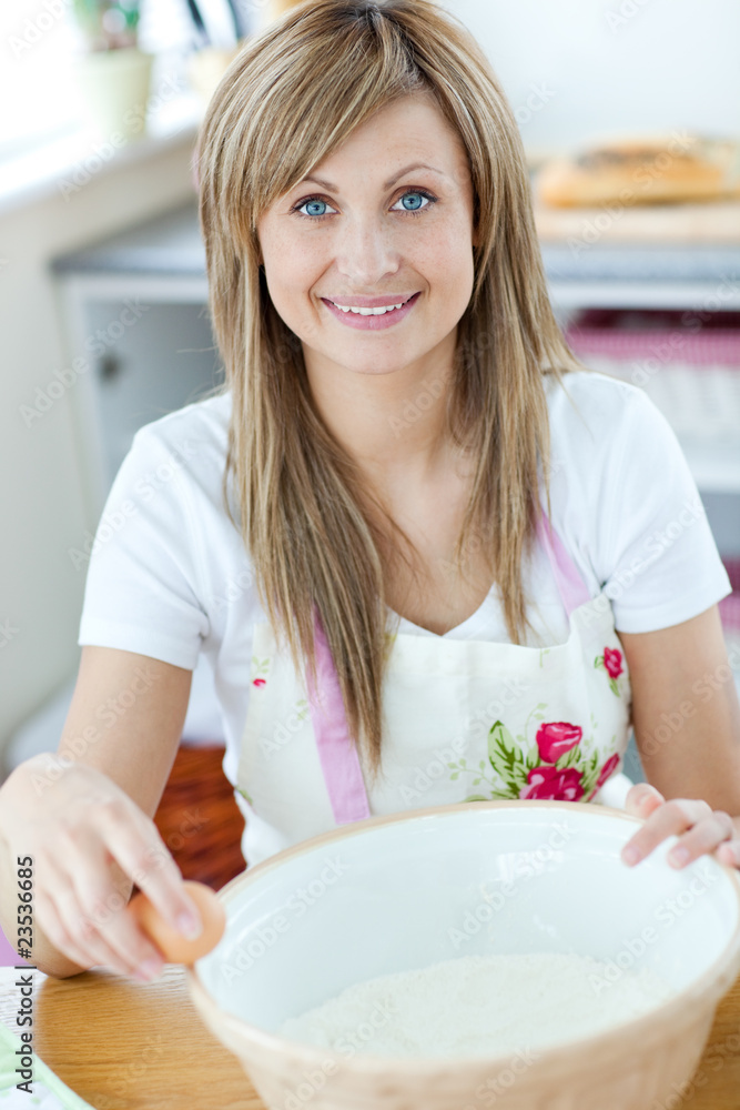 Portrait of a young woman preparing a cake in the kitchen Portrait of a young woman preparing a cake in the kitchen