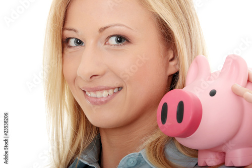 Businesswoman holding piggy bank