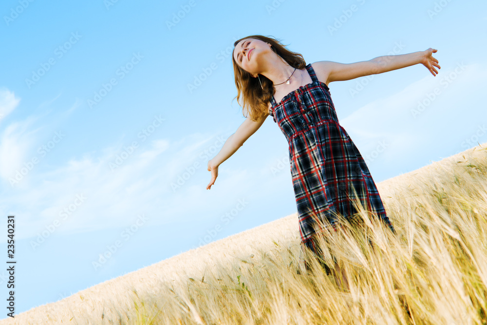 Beautiful woman in checkered dress in a field Beautiful woman in checkered dress in a field