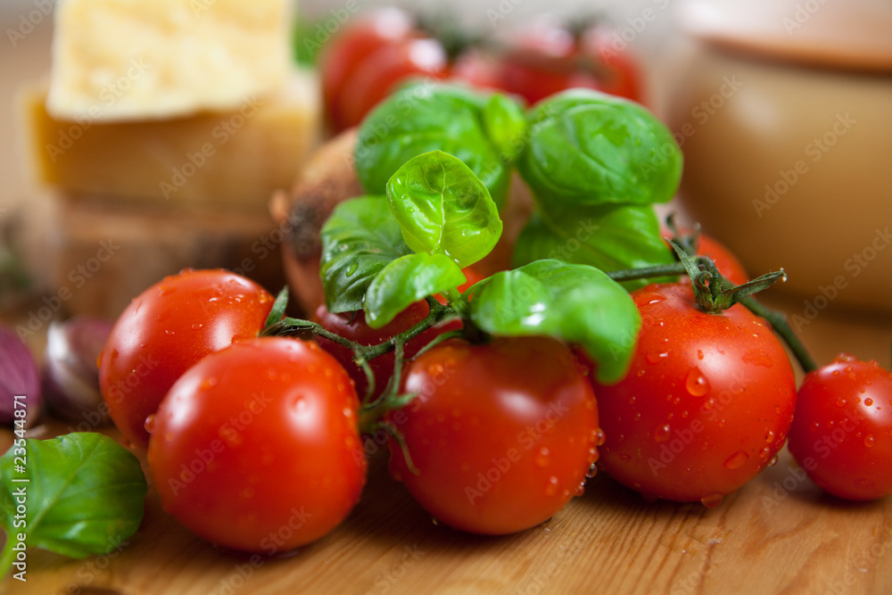 Close-up of fresh cherry tomatoes and basil Close-up of fresh cherry tomatoes and basil