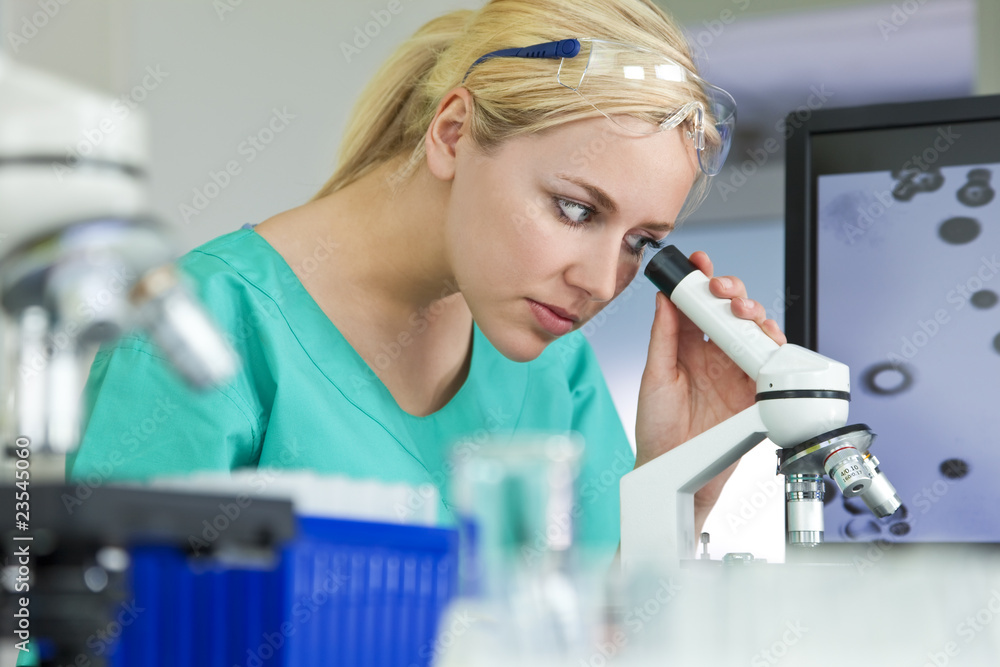 Female Scientist or Woman Doctor Using Microscope In Laboratory Female Scientist or Woman Doctor Using Microscope In Laboratory