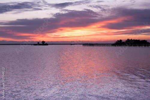 Dramatic sky before sunrise in lilaceous colors on Indian river photo
