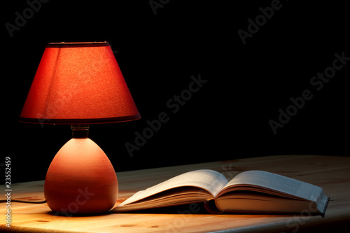 Lamp illuminating a book photo