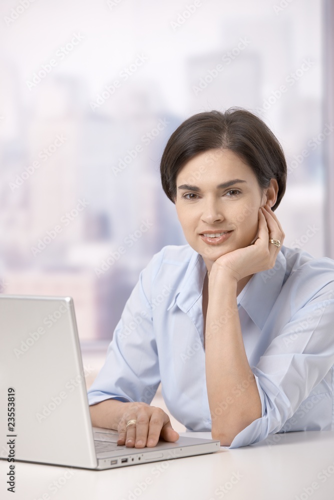 Portrait of smiling woman with computer Portrait of smiling woman with computer