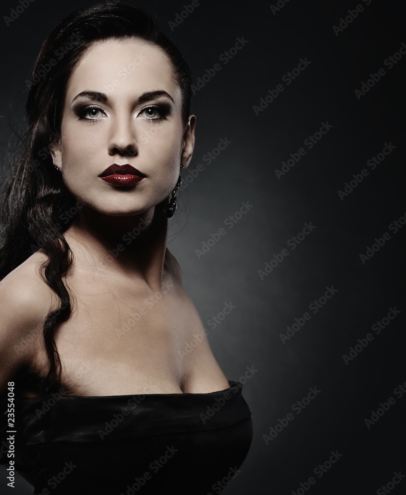 Attractive brunette woman isolated on grey background Attractive brunette woman isolated on grey background