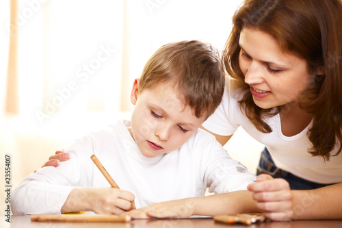 mother helping with homework to her son
