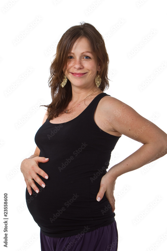 Young pregnant woman in a studio setting isolated over white. Young pregnant woman in a studio setting isolated over white.