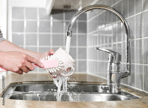 Washing a coffee cup photo