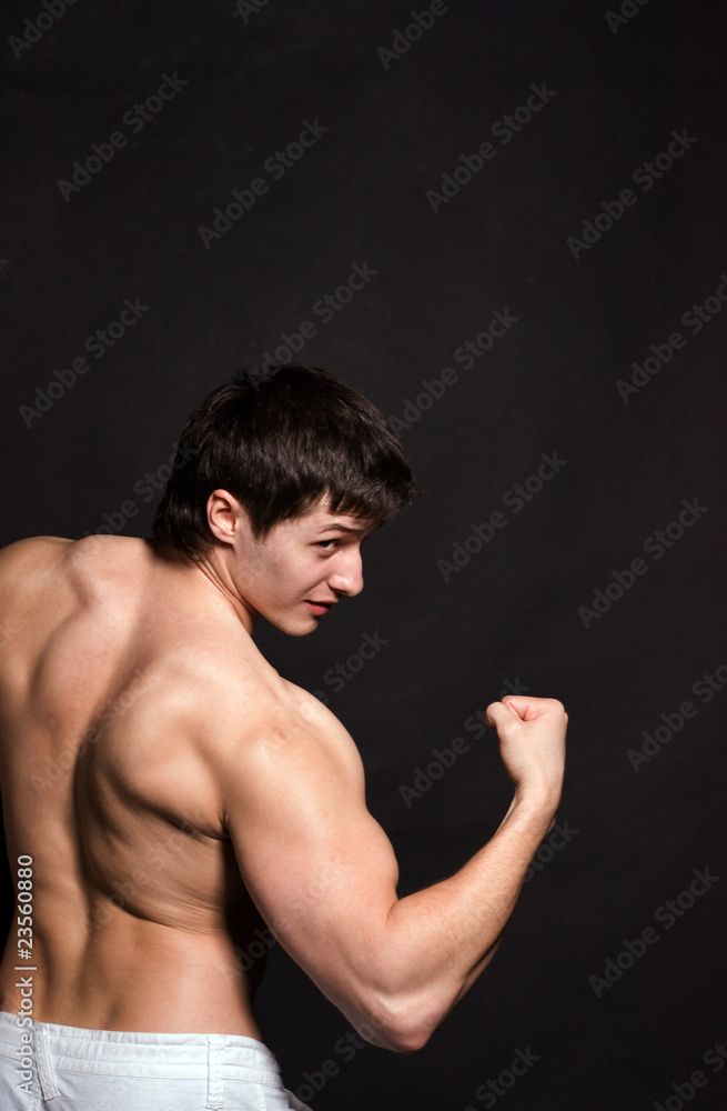 Fototapeta premium Portrait of a shirtless muscular young man