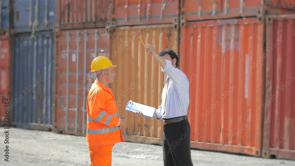 Manual worker, businessman and cargo containers Manual worker, businessman and cargo containers