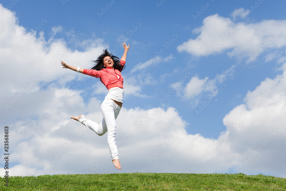 pretty young woman jumping on green grass pretty young woman jumping on green grass