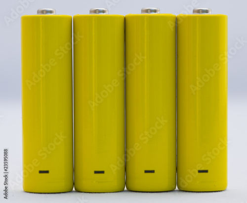 yellow small battery with positive and negative signs