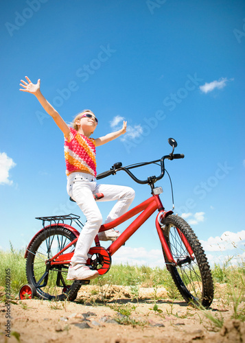 girl on red bicycle