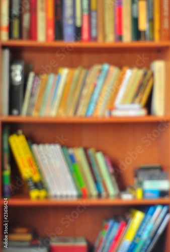 Bookcase full of books photographed with soft focus. 