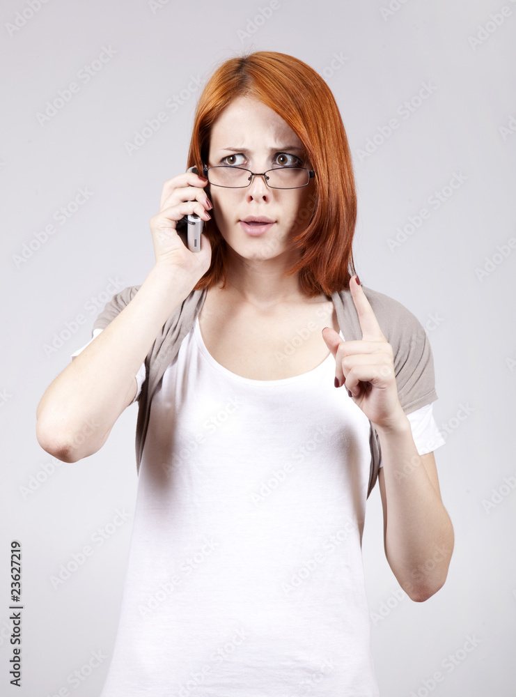 Young Businesswomen in white speaking by mobile phone. Young Businesswomen in white speaking by mobile phone.