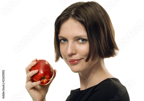 Young beautifull brunette taking an apple