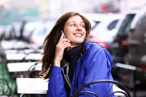 Happy young lady talking on mobile phone