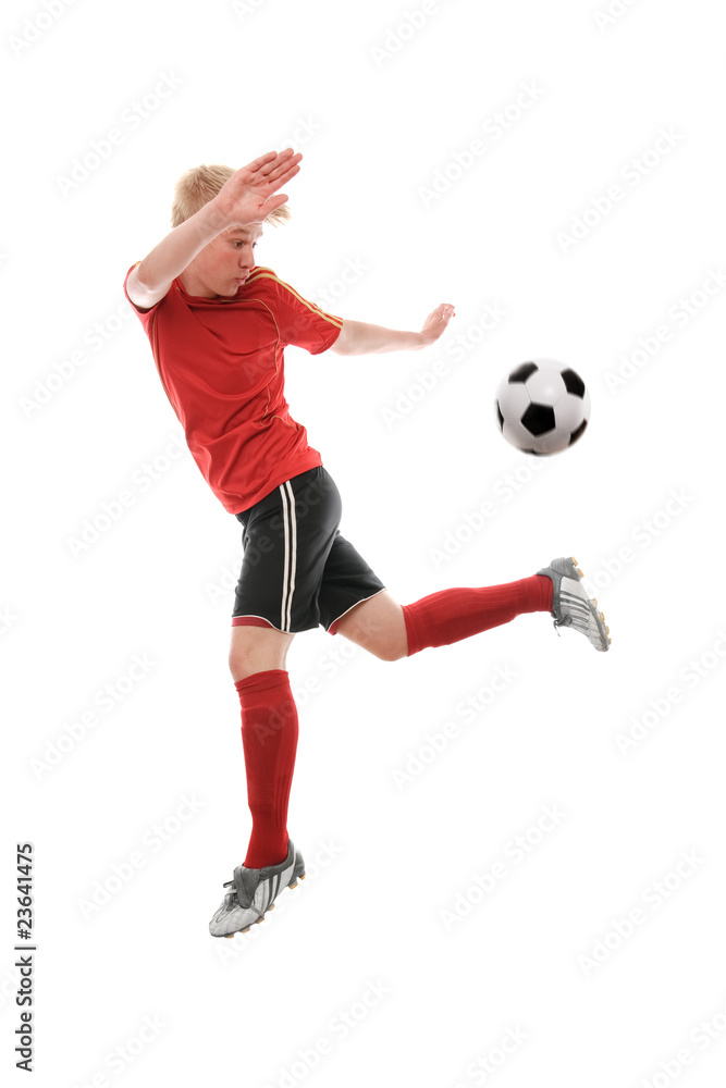 Soccer player kicking the ball isolated on white