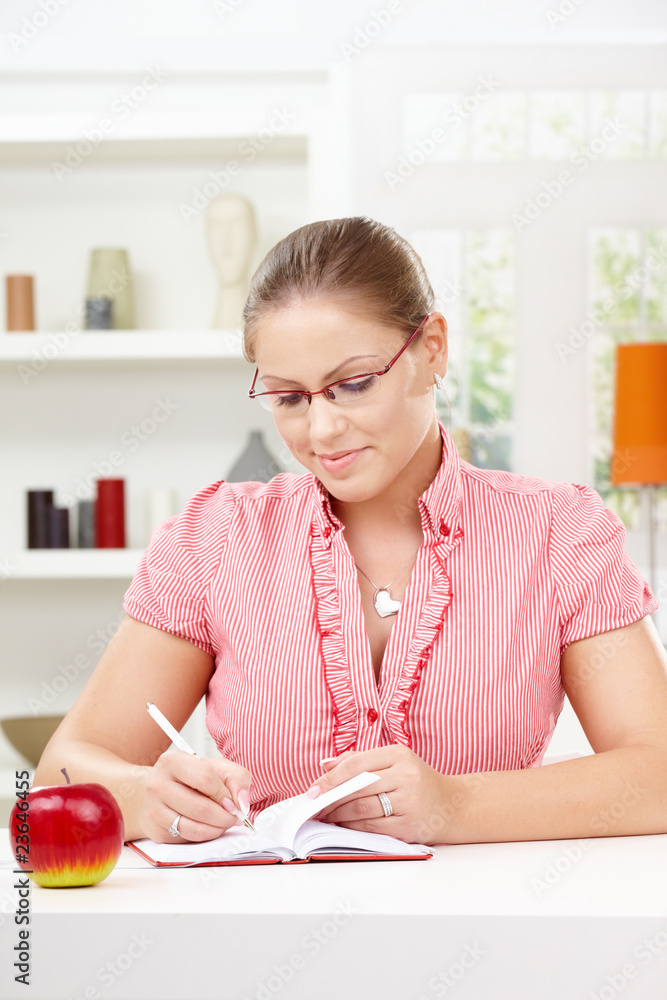 Young woman writing diary