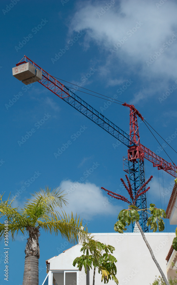Tower crane against blue sky Tower crane against blue sky