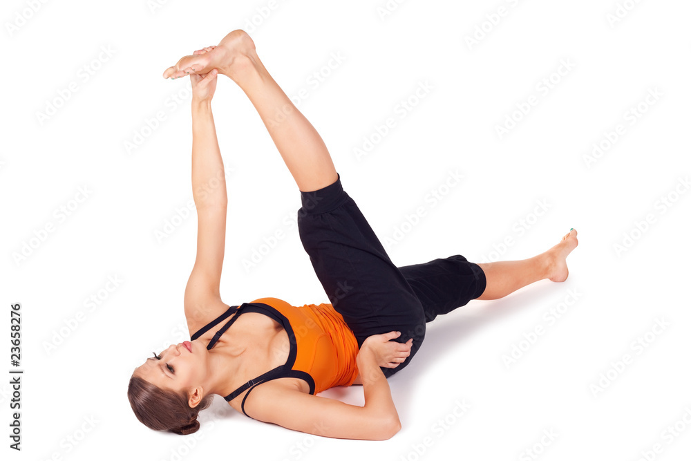 Woman Practicing Reclining Big Toe Yoga Pose Woman Practicing Reclining Big Toe Yoga Pose