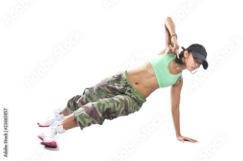 Beautiful female hip hop dancer striking a dance pose.