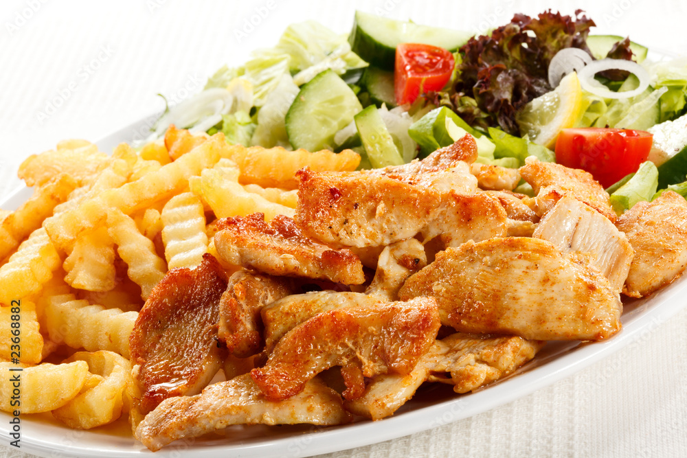 Grilled meat with fried potatoes and vegetables Grilled meat with fried potatoes and vegetables