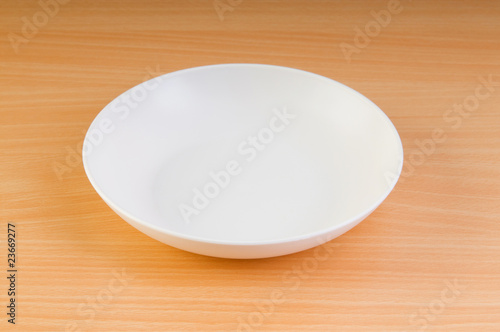 Empty plate on the wooden table