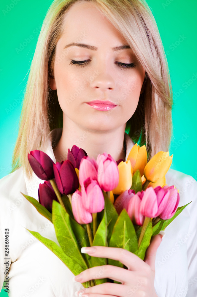Young girl with tulips against colourful background Young girl with tulips against colourful background