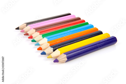 colorful pencils in a row over white background