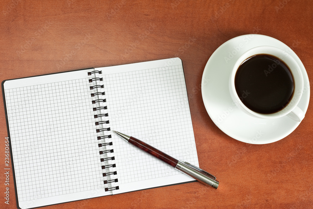 Coffee cup, spiral notebook and pen Coffee cup, spiral notebook and pen