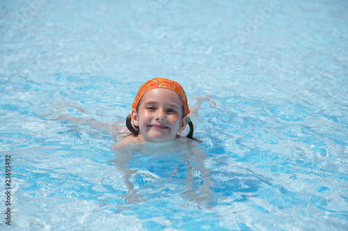 little girl in pool. blue water