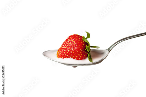 strawberry in the spoon full of yoghurt