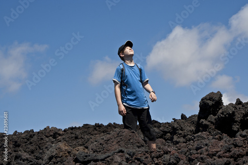 boy on walking trail thru volcanic area in Lanzarote © travelview