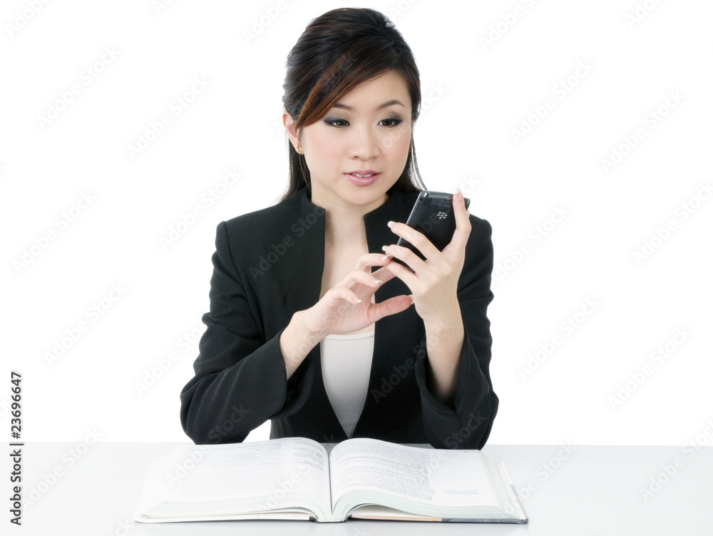 Beautiful young businesswoman text messaging on cellphone Beautiful young businesswoman text messaging on cellphone