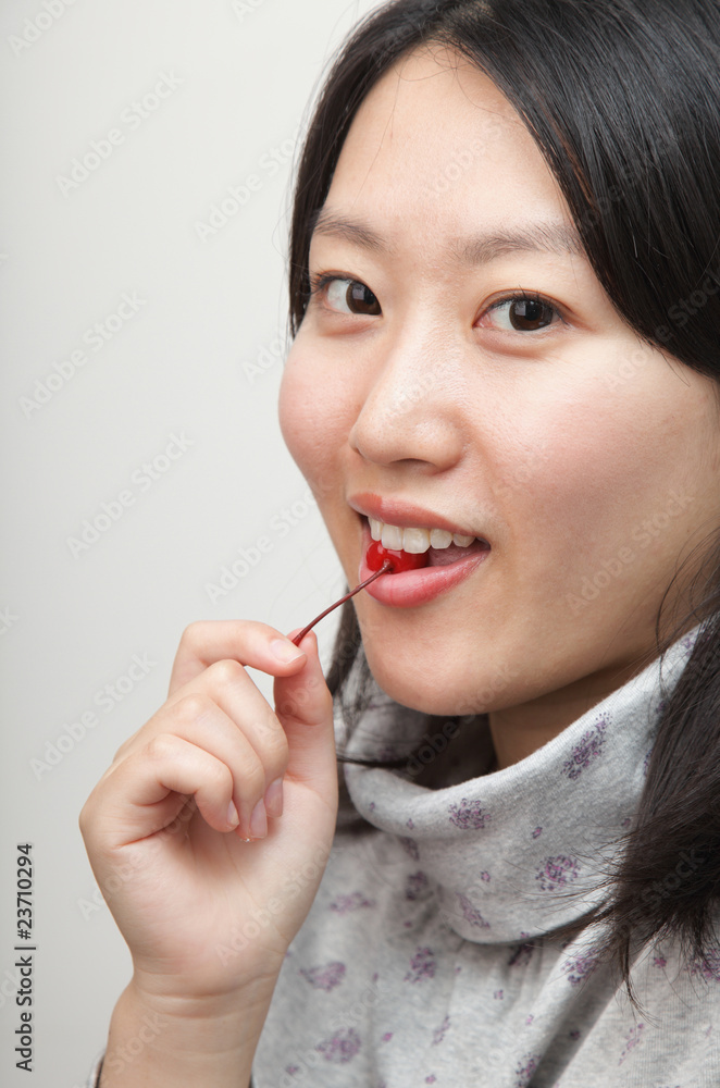 young lady tasting a cherry young lady tasting a cherry