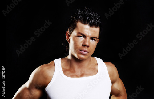young handsome man with muscles over dark