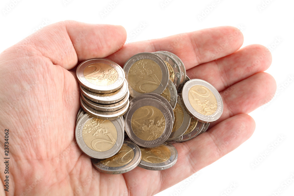 Open hand showing several euro coins isolated on white Open hand showing several euro coins isolated on white