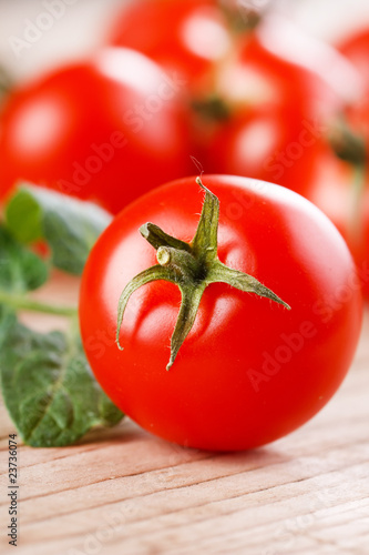 Cherry tomatoes on the wood background