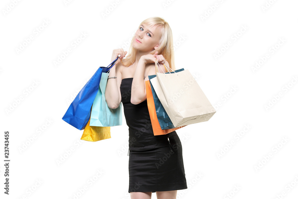 A smiling young female posing with shopping bags A smiling young female posing with shopping bags