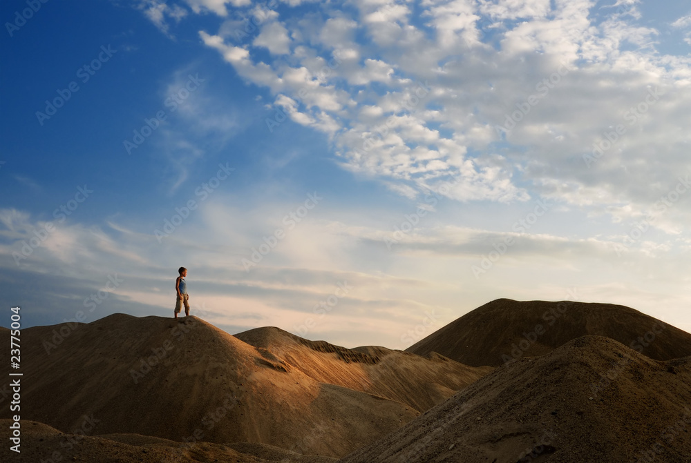 young man in sand desert in sundown silhouette young man in sand desert in sundown silhouette