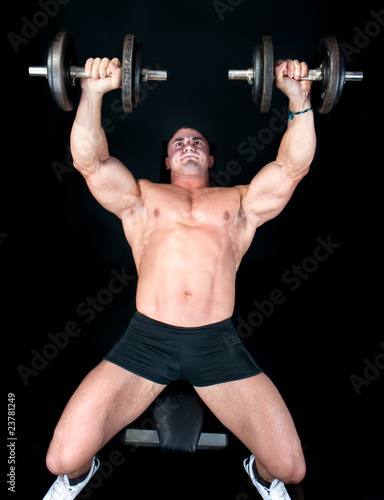 Man on bench with a bar weights in hands training