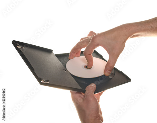 Men's hand holding DVD CD disc on white background isolated