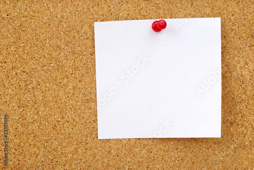 closeup of note paper on cork board