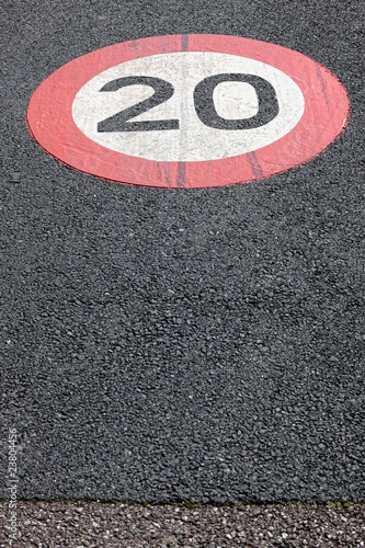 20 kph speed limit sign painted on surface of a bicycle path