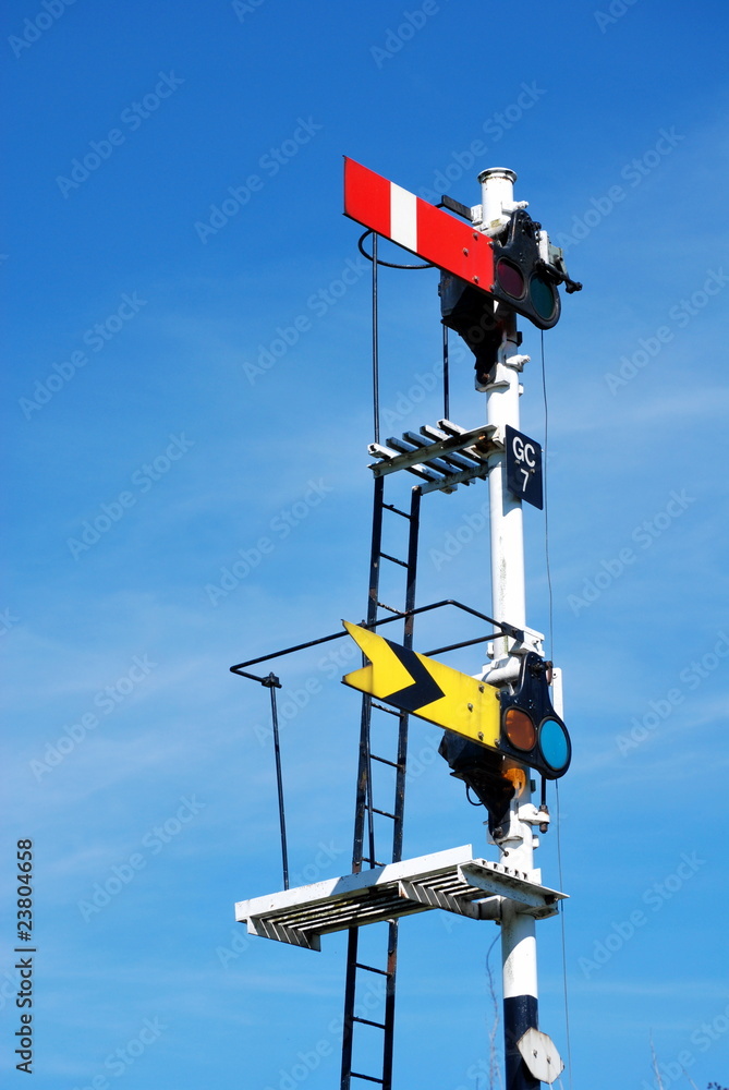 Fototapeta premium Old Railway Signals in UK against blue sky with copyspace in Pickering North Yorkshire