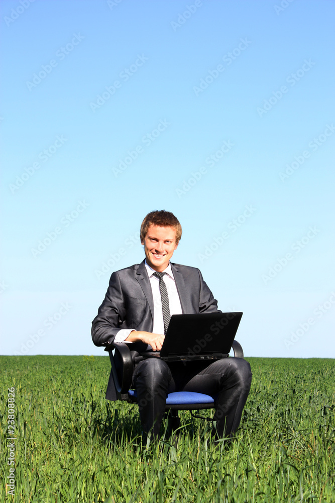 Young guy businessman. In the suit, on the field Young guy businessman. In the suit, on the field